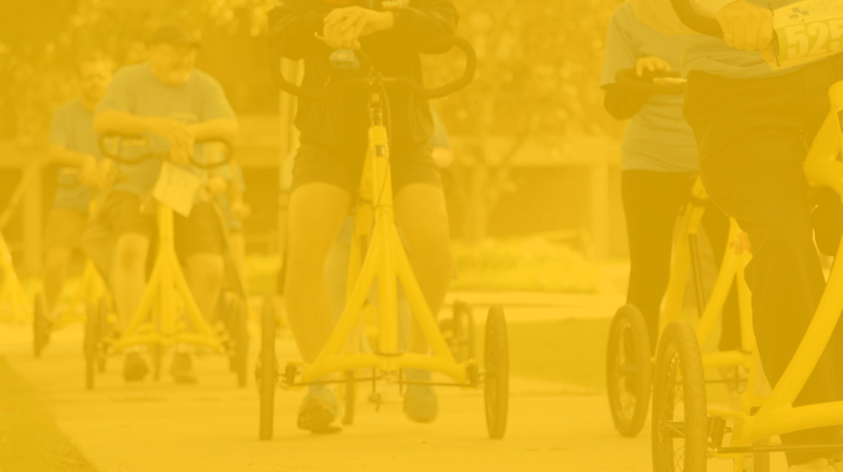 yellow background image of people riding the alinker