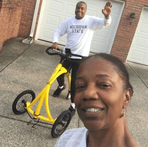 African American couple taking selfie with man on alinker
